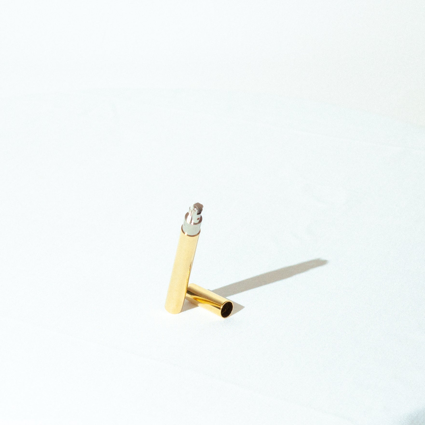 tsubota pearl luxury designer lighter in the shape of a cigarette with a brass outer